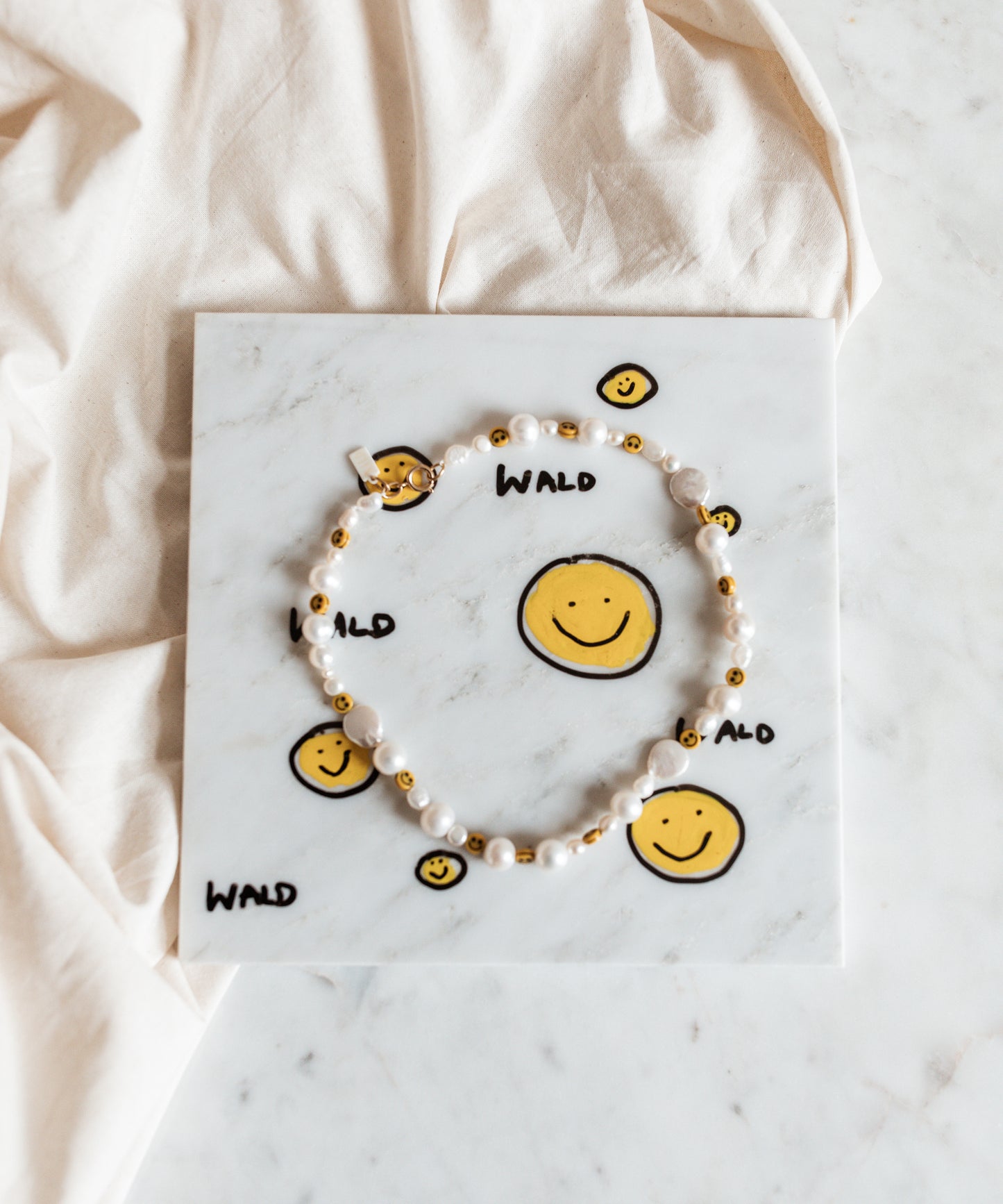 A jewelry piece by WALD Berlin featuring a Smilie Dude Marble Art pendant, proudly made in Germany.