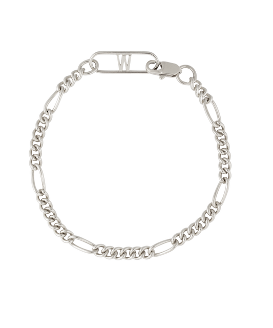 The Naomi Bracelet Silver by WALD Berlin features alternating curb and elongated links, inspired by German design, with a clasp and a bar topped with the letter "W.