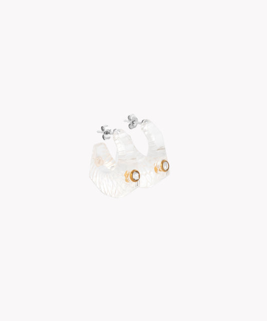 Introducing the Shining Star Crystal Earrings by WALD Berlin: a pair of translucent, textured hoop earrings featuring a small metallic detail near the fastening and elegantly accented with 18k gold-plated Sterling silver.