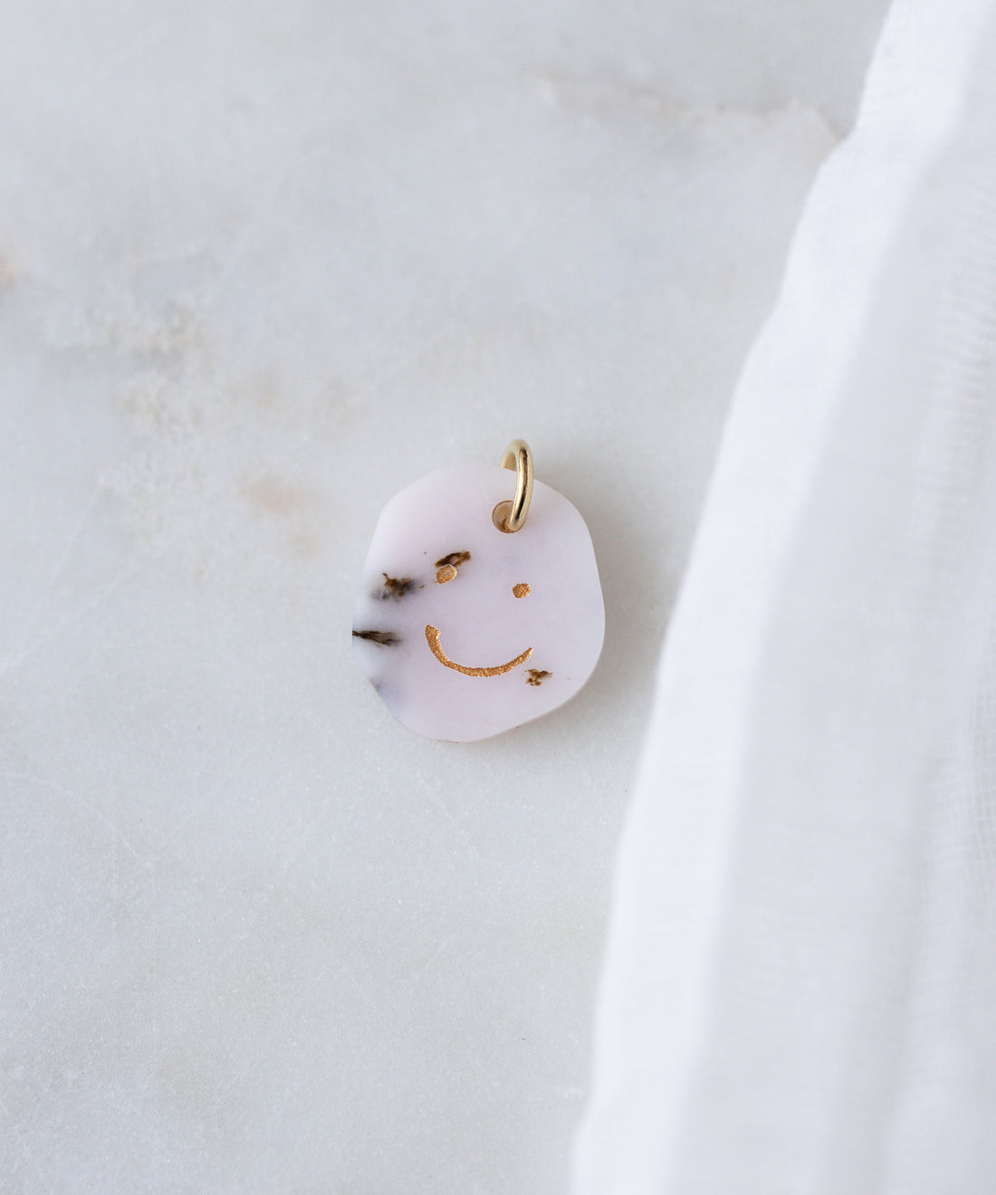 The WALD Berlin Smilie Dude Gemstone Pendant Without Chain features a playful gold smiley face design and is crafted in Germany—perfect as a unique accent for any look.