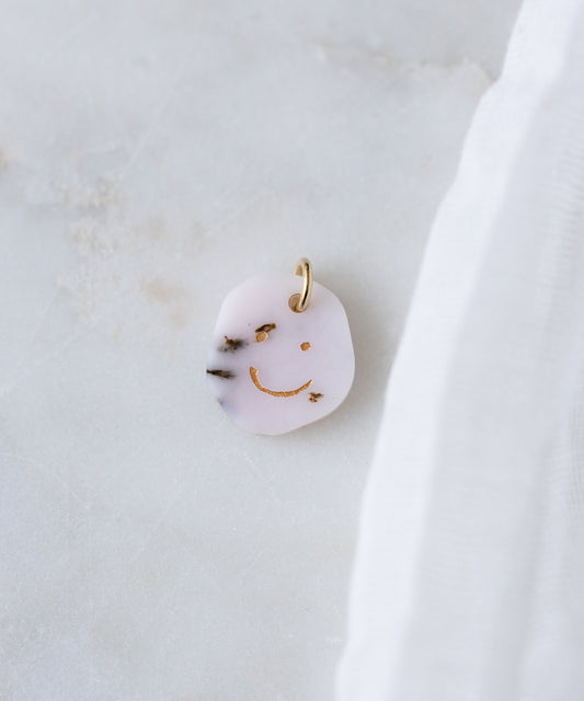 The WALD Berlin Smilie Dude Gemstone Pendant Without Chain features a playful gold smiley face design and is crafted in Germany—perfect as a unique accent for any look.