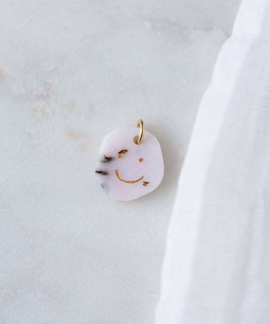 The WALD Berlin Smilie Dude Gemstone Pendant Without Chain features a playful gold smiley face design and is crafted in Germany—perfect as a unique accent for any look.