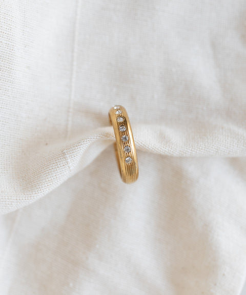 WALD Berlin Hug Me Earcuff Gold featuring a vertical row of small round clear Swarovski stones.