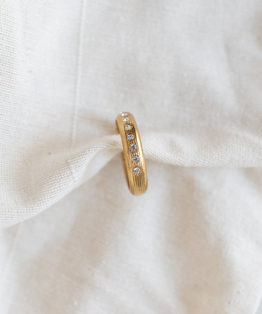 WALD Berlin Hug Me Earcuff Gold featuring a vertical row of small round clear Swarovski stones.