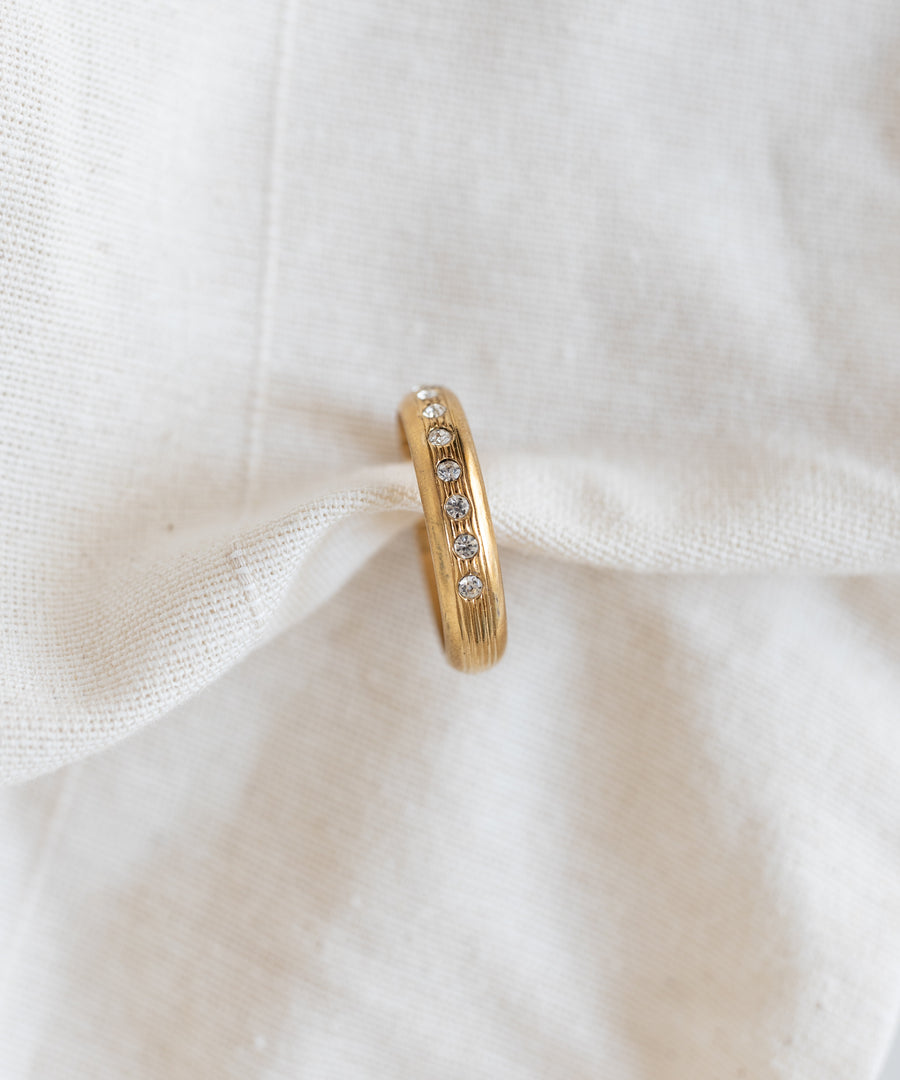 WALD Berlin Hug Me Earcuff Gold featuring a vertical row of small round clear Swarovski stones.