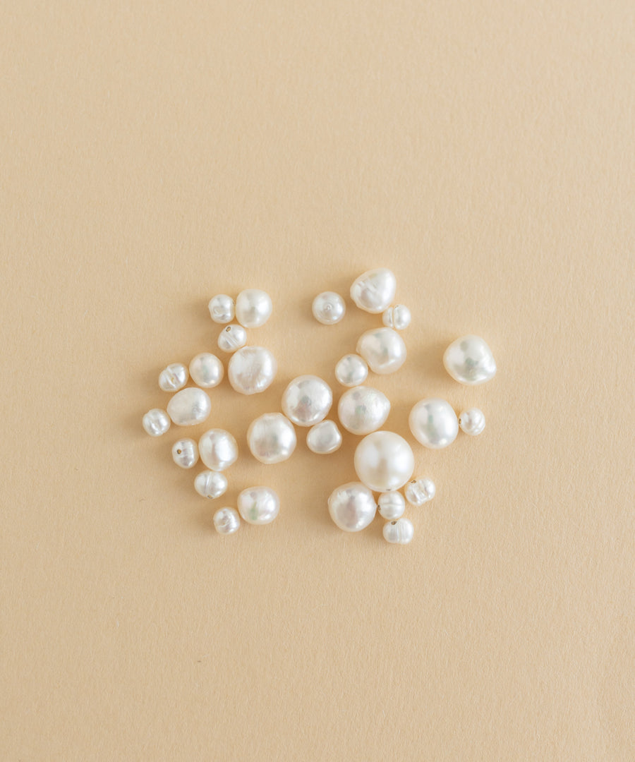 A charm-filled kit of Sweet Water Pearls from WALD World showcased on a beige background.