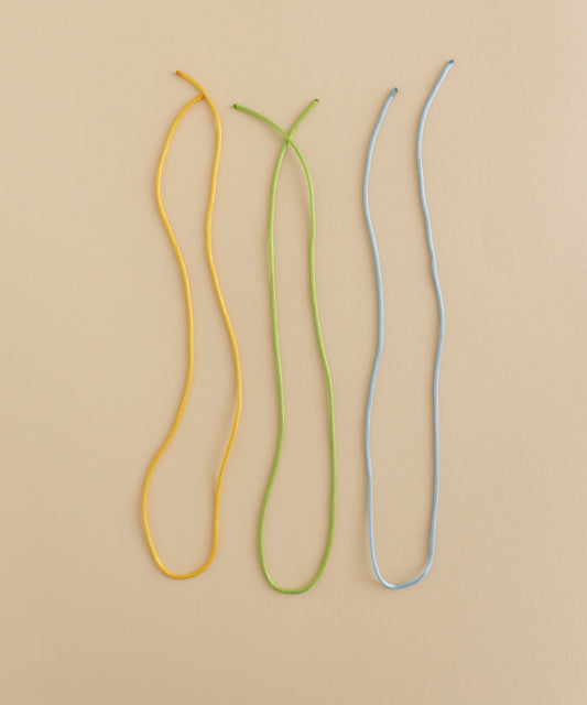 WALD World offers a DIY jewelry kit with three charming ribbon bunt cords on a beige surface.