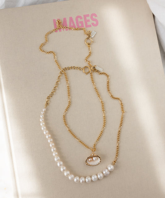 The WALD Berlin Drop It Like It’s Hot Shell Necklace is displayed on a beige book with “IMAGES” in pink lettering on the cover.