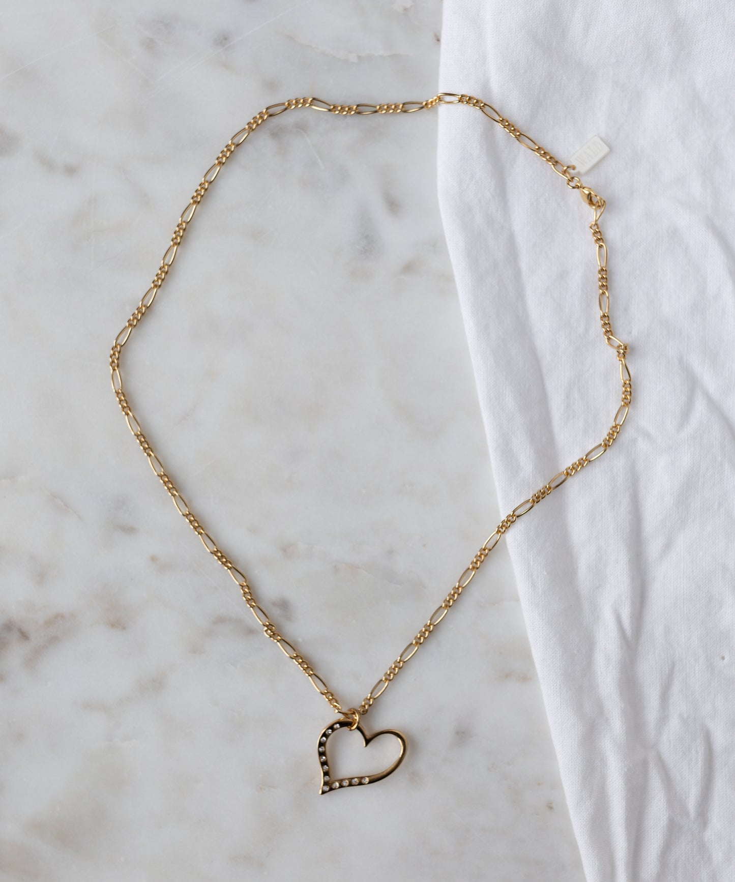 The WALD Berlin Valentine’s Day special sketch heart necklace features a goldplated brass pendant with sparkling Swarovski stones on a delicate chain.