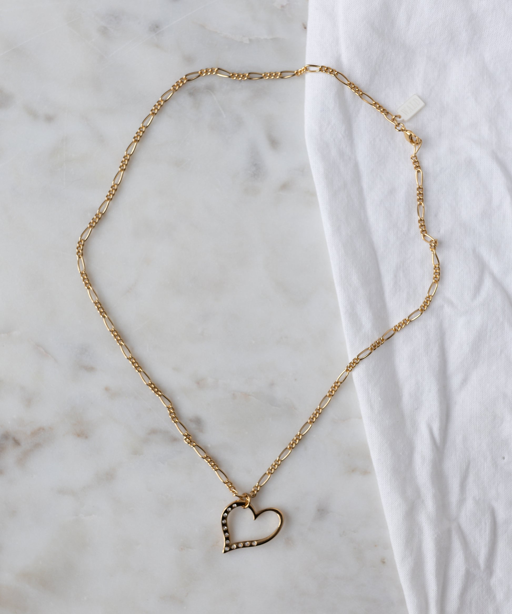 The WALD Berlin Valentine’s Day special sketch heart necklace features a goldplated brass pendant with sparkling Swarovski stones on a delicate chain.