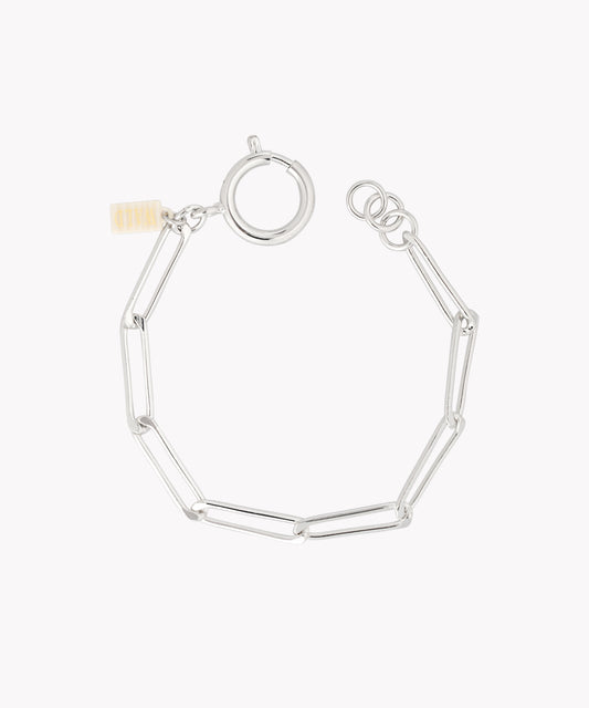 The SAMPLE SALE Ashley Bracelet Silver by WALD Berlin features elongated oval links, a round clasp, and a small rectangular tag.