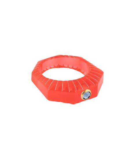 The WALD Berlin SAMPLE SALE Shining Star Red Ring is a hand-painted polyester, faceted octagonal ring in red with a single round blue Swarovski stone set on one side.
