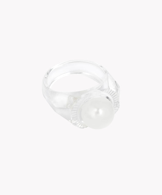 The Happy No No No Ring SAMPLE by WALD Berlin features a large Swarovski pearl accent on a transparent ring crafted from bio polyester. Made in Germany, it's set against a plain white background.