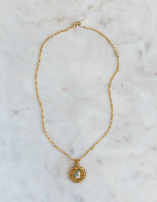 The WALD Berlin Sample saleSay My Name Gold Necklace features a gold-plated chain with a round turquoise and gold letter "J" pendant, displayed on light marble—a stylish initial necklace for any occasion.