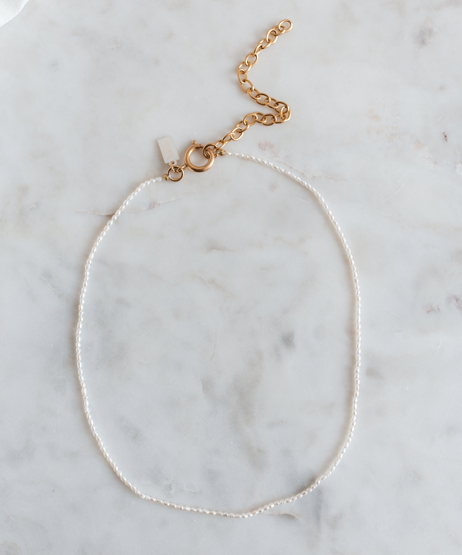 A Fine Rice Pearl Necklace with a gold chain, jewelry from WALD Berlin.