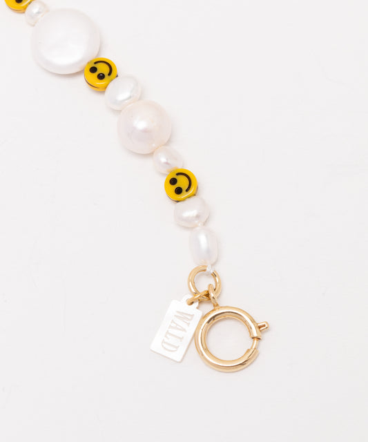 A Smilie Dude Pearl Necklace with pearls and a charm by WALD Berlin.
