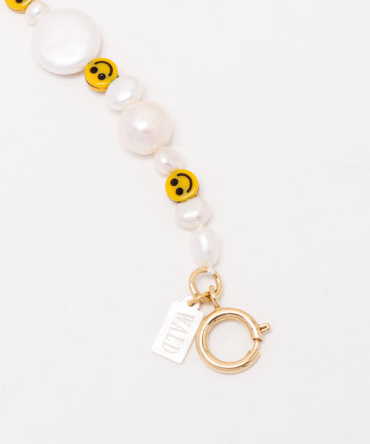 A Smilie Dude Pearl Necklace with pearls and a charm by WALD Berlin.
