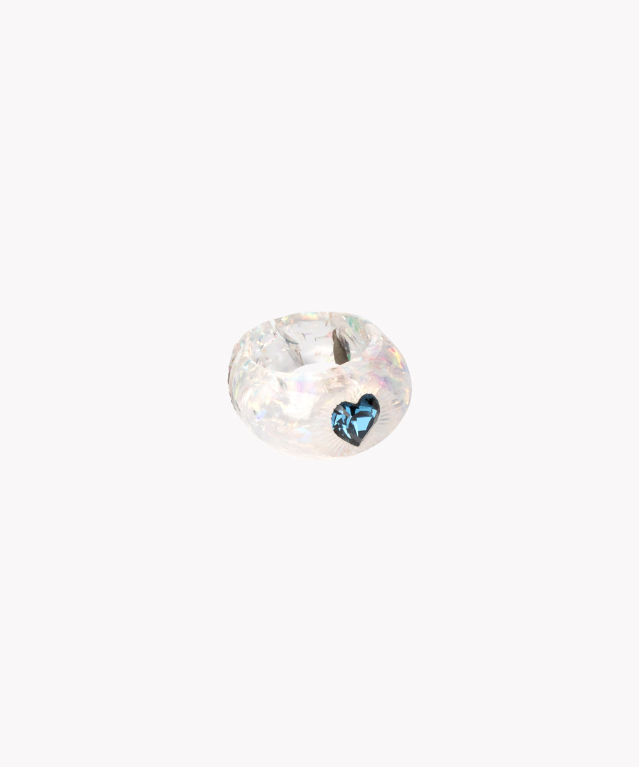 The SAMPLE Zeena x WALD Blue Heart Ring by WALD Berlin features a round, iridescent glass bead with a blue heart detail, capturing romantic charm against a plain white background.