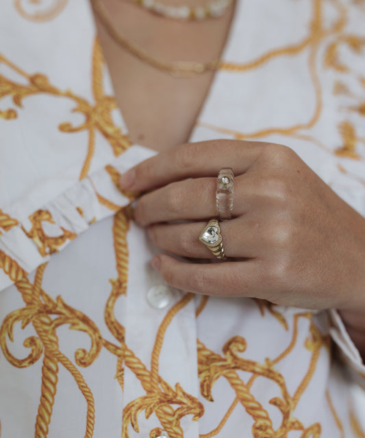 A woman adorned in german jewelry, including the Shining Star Crystal Ring, from WALD Berlin.
